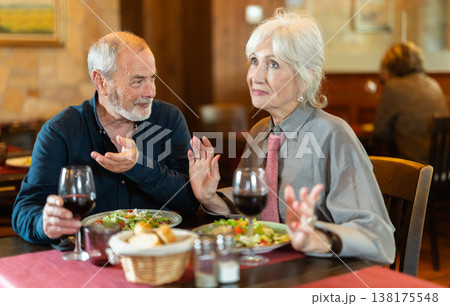 Mature couple communicate and chatting during date in cafe Mature couple communicate and chatting during date in cafe 138175548