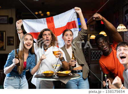 Group of England football team fans spending time in bar Group of England football team fans spending time in bar 138175654