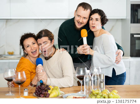 Group of friends are having fun singing karaoke during feast and gatherings. Group of friends are having fun singing karaoke during feast and gatherings. 138175774