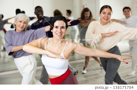 Happy Latina enjoying active dancing during group training Happy Latina enjoying active dancing during group training 138175784