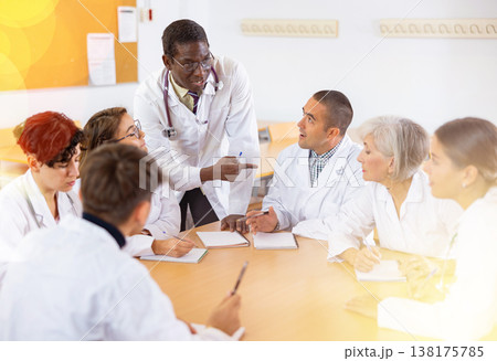 Group of doctors having discussion in classroom of medical university Group of doctors having discussion in classroom of medical university 138175785