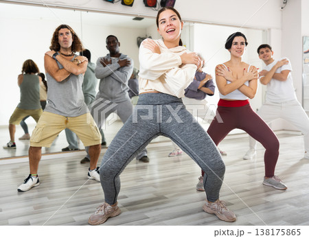 Girl learning to dance krump with group in choreographic studio Girl learning to dance krump with group in choreographic studio 138175865