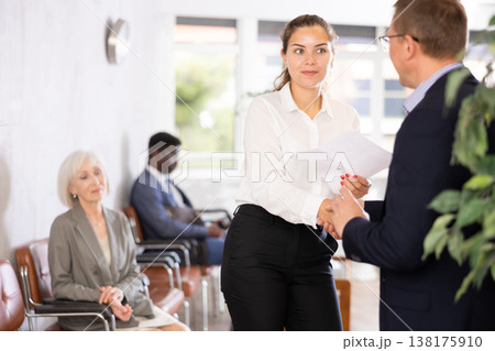 Adult man and young woman make an agreement Adult man and young woman make an agreement 138175910