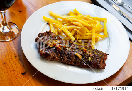 Delicious grilled beef with french fries at the plate Delicious grilled beef with french fries at the plate 138175914