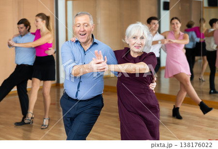 Aged couple learning partner swing in dance class 138176022