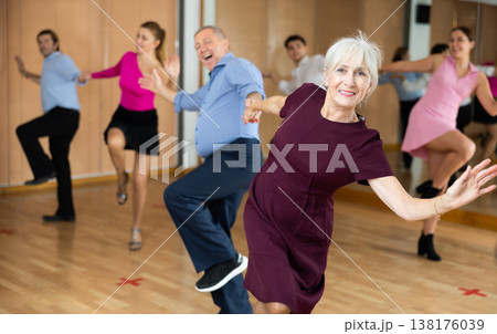 Older woman enjoying active dancing in dance studio Older woman enjoying active dancing in dance studio 138176039