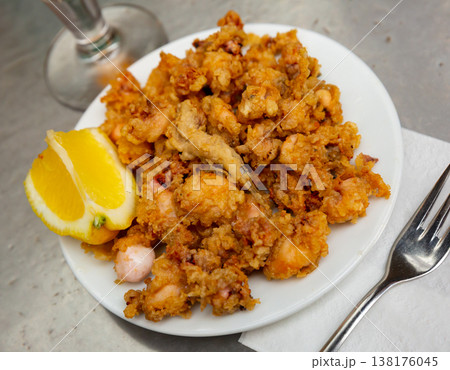 Battered fried baby squid with lemon Battered fried baby squid with lemon 138176045