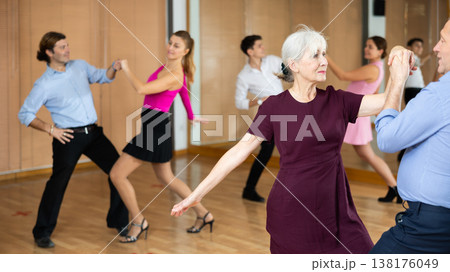 Elderly woman dancing playful balboa with partner in studio Elderly woman dancing playful balboa with partner in studio 138176049