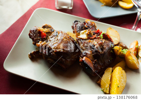 Appetizing fried pork cheeks with potatoes Appetizing fried pork cheeks with potatoes 138176068