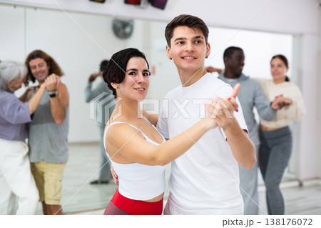 Caucasian man and lady rehearsing latin paired dance moves 138176072