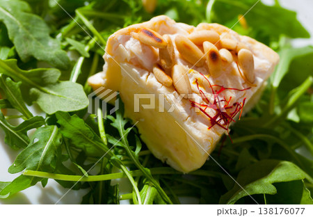 Camembert on arugula with pine nuts Camembert on arugula with pine nuts 138176077