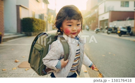 Candid documentary of a diverse young child walking to school with a backpack in natural light, showing a real life morning routine and healthy work life balance for a modern active family 138176418