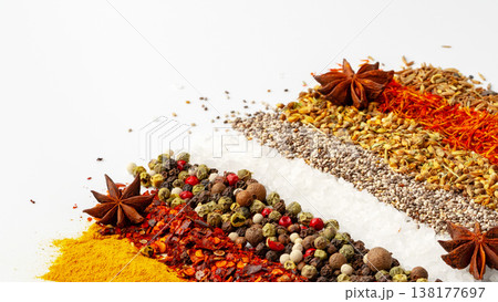 Colorful collection of spices arranged neatly with salt on a white background 138177697