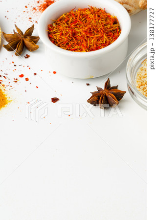 Spices and herbs laid out on a table with bowls and spilled contents in a cooking scene 138177727