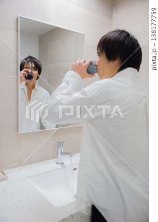洗面所で歯磨きをする男性 138177759