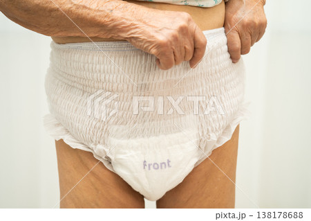 Asian senior woman patient wearing adult incontinence diaper pad in hospital. 138178688
