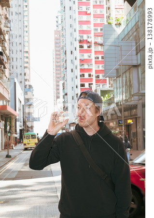 Scandinavian Man Drinking Water in Hong Kong City Street 138178993
