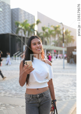 Thai Woman Using Smartphone in Hong Kong Square Thai Woman Using Smartphone in Hong Kong Square 138179076