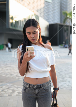 Thai Woman Using Smartphone in Hong Kong Square Thai Woman Using Smartphone in Hong Kong Square 138179077