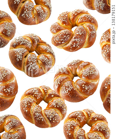 Multiple twisted pretzel buns or bagel with coarse salt topping arranged in seamless pattern isolated on white background Multiple twisted pretzel buns or bagel with coarse salt topping arranged in seamless pattern isolated on white background 138179151