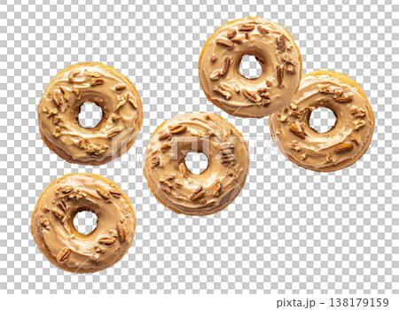 Top view of multiple maple glazed donuts with chopped pecans, isolated on white background, concept of sweet pastry pattern Top view of multiple maple glazed donuts with chopped pecans, isolated on white background, concept of sweet pastry pattern 138179159