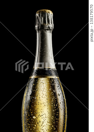 Champagne bottle with rising bubbles and silver foil on black backdrop with clipping path, symbolizing celebration and elegance 138179570