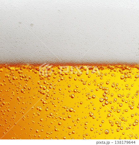 Closeup of beer with rising bubbles and foam on a white background showing freshness concept 138179644