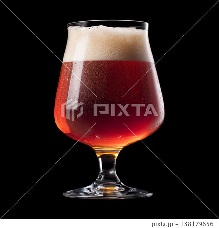 Foamy red ale beer in a tall tulip glass with creamy foam head, isolated on black background, concept of refreshment and taste 138179656