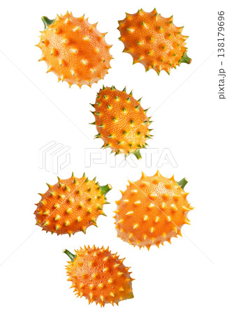 Multiple horned orange kiwano fruits with green tips isolated on white background, concept of exotic fruit freshness 138179696