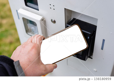 Person using smartphone for contactless payment at terminal 138180959
