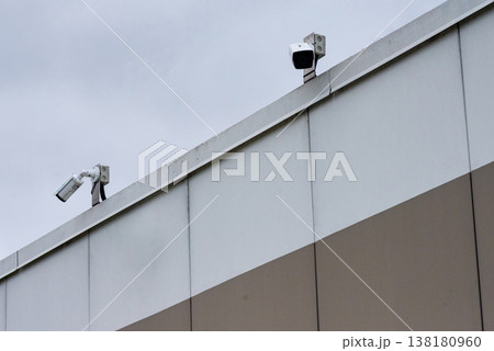 Security cameras installed on top of modern building wall Security cameras installed on top of modern building wall 138180960