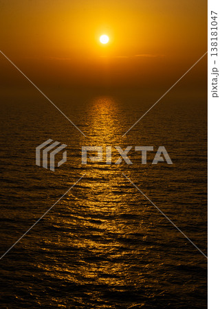 Sunset over sea horizon with golden sun path on water Sunset over sea horizon with golden sun path on water 138181047