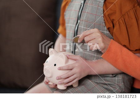Mother teaching child financial savings with piggy banks Mother teaching child financial savings with piggy banks 138181723