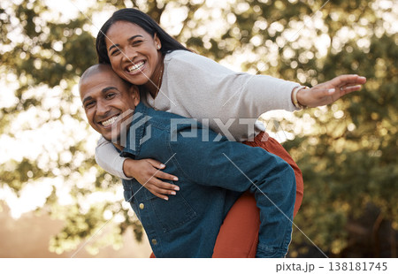 Couple, park and piggy back with smile, portrait and airplane game in nature, holiday and bonding in summer. Man, woman and playful in backyard, freedom and vacation by trees with love in sunshine Couple, park and piggy back with smile, portrait and airplane game in nature, holiday and bonding in summer. Man, woman and playful in backyard, freedom and vacation by trees with love in sunshine 138181745