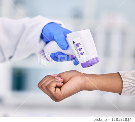 Doctor, hands and thermometer for patient temperature, fever or checkup appointment at hospital. Closeup of medical nurse or surgeon checking customer with infrared scanner for virus or flu at clinic Doctor, hands and thermometer for patient temperature, fever or checkup appointment at hospital. Closeup of medical nurse or surgeon checking customer with infrared scanner for virus or flu at clinic 138181834