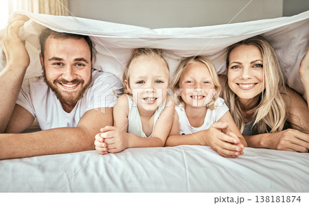 Happy, smile and portrait of family on the bed with blanket for bonding and relaxing together at home. Happiness, love and girl children laying with parents from Australia in bedroom at modern house. 138181874
