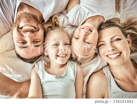 Happy, smile and portrait of family on a bed for bonding and relaxing together at modern home. Happiness, love and top view of girl children laying with parents from Australia in bedroom at house. 138181882