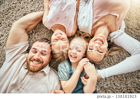 Smile, portrait and kids with parents in the living room bonding and relaxing together at home. Happy, love and girl children laying with mother and father from Australia on floor in lounge at house. 138181923