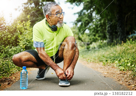 Senior man, tie and shoes in fitness for running, workout or outdoor exercise on road, nature or asphalt. Mature male person and tying shoe getting ready or preparation for path, cardio or run Senior man, tie and shoes in fitness for running, workout or outdoor exercise on road, nature or asphalt. Mature male person and tying shoe getting ready or preparation for path, cardio or run 138182212