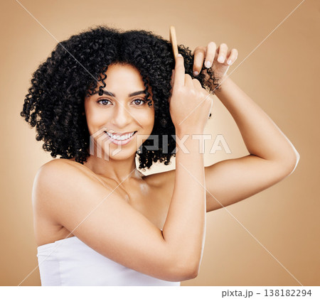 Curly, hair comb and portrait of happy woman in studio for natural beauty, shine or coil texture on brown background. Model, smile and brush afro hairstyle for salon aesthetic, keratin growth or care 138182294