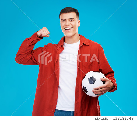 Portrait, football and happy man with strong muscle in studio isolated on a blue background. Face, soccer and excited person flex bicep for power, sports and success in competition, winner or fitness Portrait, football and happy man with strong muscle in studio isolated on a blue background. Face, soccer and excited person flex bicep for power, sports and success in competition, winner or fitness 138182348