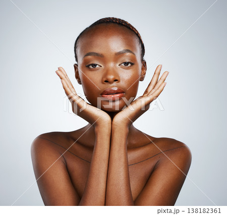 Portrait, skin and hands of a black woman in studio on a gray background for skincare, beauty or natural wellness. Face, spa or luxury and a young model with cosmetic or antiaging aesthetic treatment 138182361