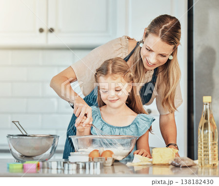 Mom, girl child and learning with whisk, development and skills with bonding, love or care in family house. Cooking, mother and daughter with smile, flour and eggs on table, kitchen and help for food 138182430