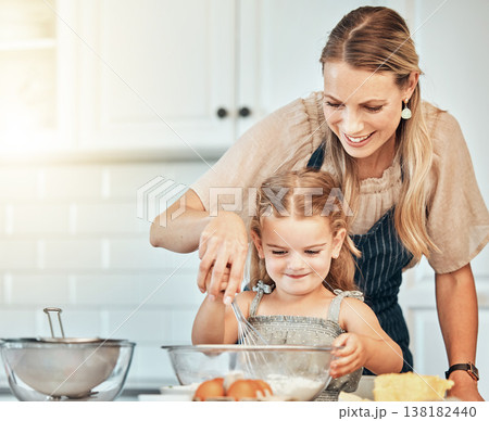Mom, girl child and teaching with whisk, development and skills with baking, love and care in family home. Cooking, mother and daughter with smile, flour and eggs on table, kitchen and help for food Mom, girl child and teaching with whisk, development and skills with baking, love and care in family home. Cooking, mother and daughter with smile, flour and eggs on table, kitchen and help for food 138182440