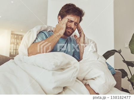 Stress, headache and sick man on a sofa with burnout, vertigo or pain from insomnia at home. Anxiety, migraine and male person in a lounge with temple massage for dizziness, congestion or head cold 138182477