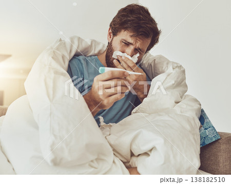 Thermometer, sneeze and sick man on sofa with headache, fever or influenza crisis at home. Anxiety, high temperature and male with toilet paper, worry or blowing nose in living room with covid fear Thermometer, sneeze and sick man on sofa with headache, fever or influenza crisis at home. Anxiety, high temperature and male with toilet paper, worry or blowing nose in living room with covid fear 138182510