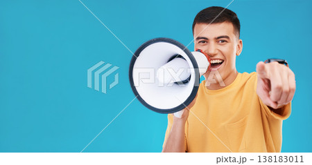 Megaphone, smile and portrait of man in studio pointing for announcement, speech or rally. Happy, protest and young person from Canada with bullhorn for loud communication isolated by blue background Megaphone, smile and portrait of man in studio pointing for announcement, speech or rally. Happy, protest and young person from Canada with bullhorn for loud communication isolated by blue background 138183011
