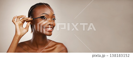 Makeup, woman and mascara for beauty, cosmetics and eyelash extension in studio on brown background. Banner, african model and brush lashes for skincare application, mockup space and aesthetic tools 138183152