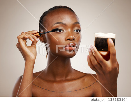 Black woman, mascara with brush and mirror for beauty, makeup and shine isolated on brown background. Eyelash extension, wand and skin glow with cosmetology, transformation and wellness in studio Black woman, mascara with brush and mirror for beauty, makeup and shine isolated on brown background. Eyelash extension, wand and skin glow with cosmetology, transformation and wellness in studio 138183164