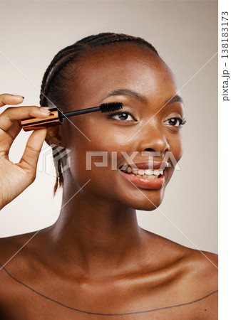Mascara, happy woman and makeup in studio for beauty, cosmetics and smile on brown background. African model, makeover and brush lashes for skincare application, aesthetic tools and eyelash extension 138183173